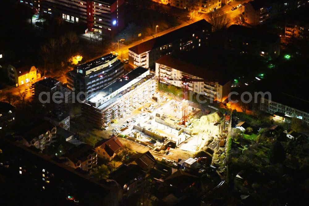 Aerial photograph at night Berlin - Night lighting Construction site to build a new multi-family residential complex along the Einbecker Strasse in the district Lichtenberg in Berlin, Germany