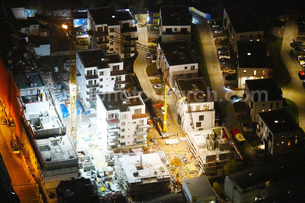 Berlin at night from above - Night lighting Construction site to build a new multi-family residential complex Das Lichtenhain on Lueckstrasse - Im Lichtenhain in the district Lichtenberg in Berlin, Germany