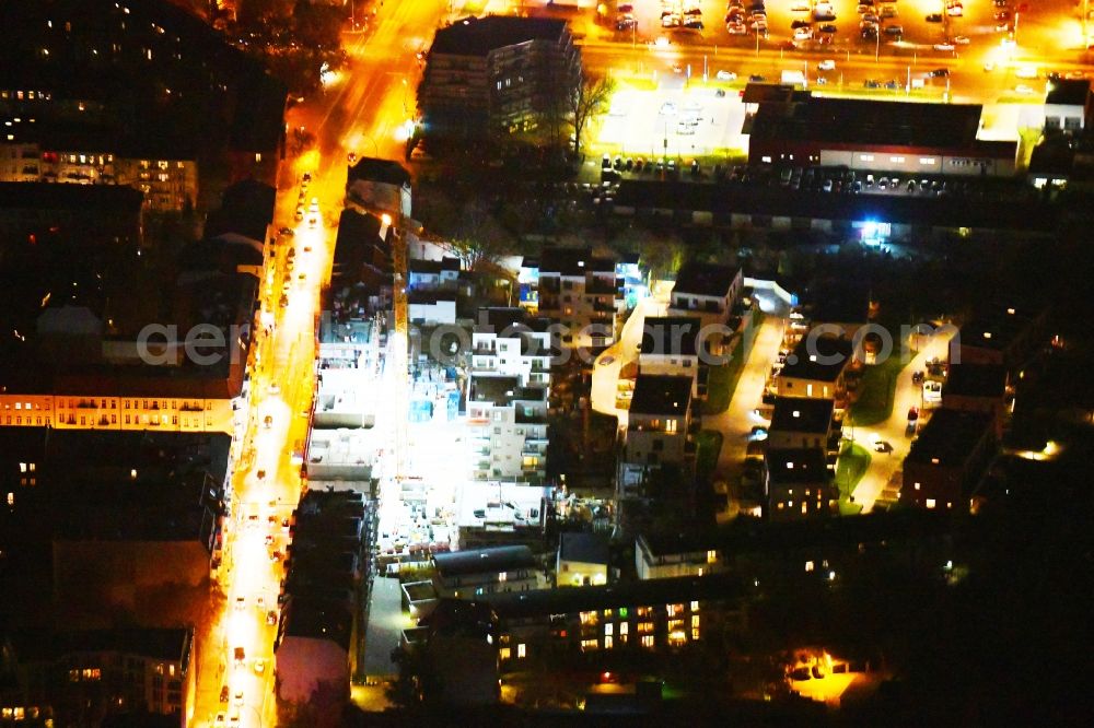 Aerial photograph at night Berlin - Night lighting Construction site to build a new multi-family residential complex Das Lichtenhain on Lueckstrasse - Im Lichtenhain in the district Lichtenberg in Berlin, Germany