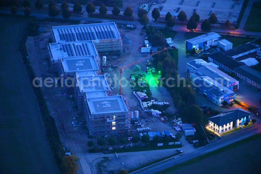 Aerial image at night Lindenberg - Night lighting new construction site of the school building between Ahrensfelof Chaussee in Lindenberg in the state Brandenburg, Germany