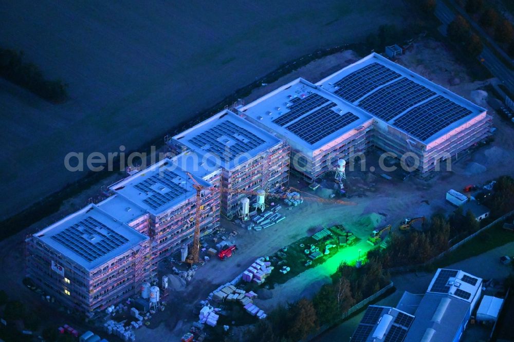 Lindenberg at night from above - Night lighting new construction site of the school building between Ahrensfelof Chaussee in Lindenberg in the state Brandenburg, Germany