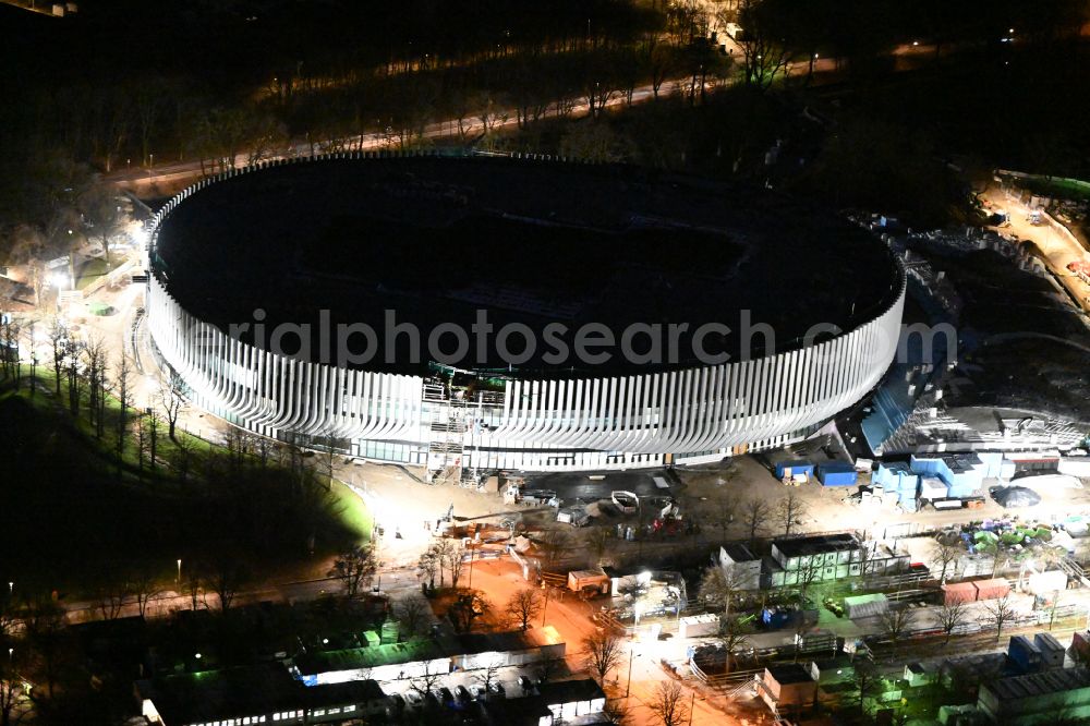 München at night from the bird perspective: Night lighting construction site for the new sports hall SAP Garden in Olympiapark on street Toni-Merkens-Weg in the district Milbertshofen-Am Hart in Munich in the state Bavaria, Germany