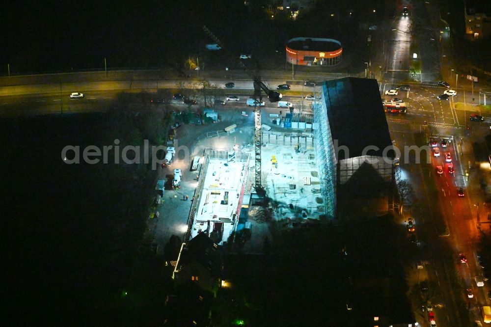 Aerial photograph at night Berlin - Night lighting construction site for the multi-family residential building on Hindenburgdamm corner Koenigsberger Strasse in the district Lichterfelde in Berlin, Germany