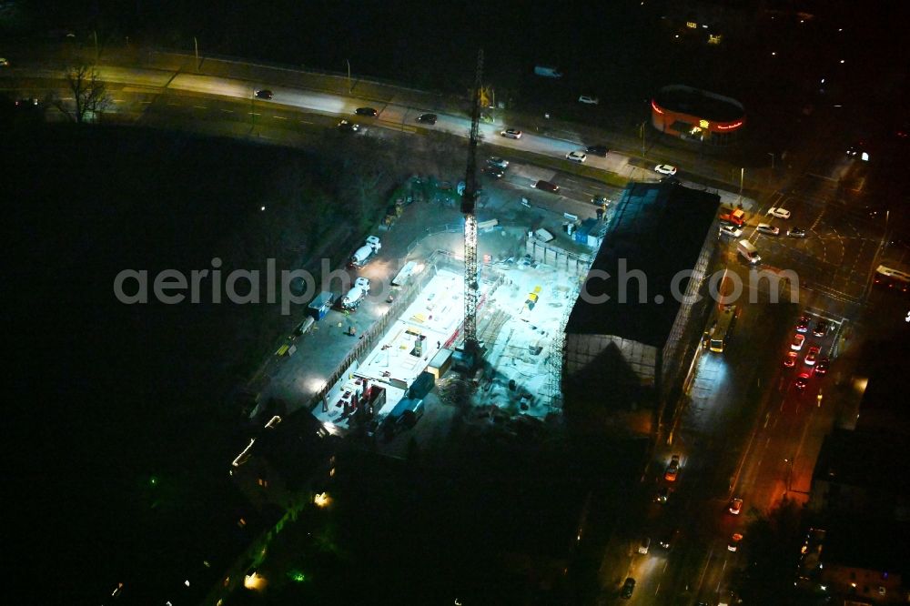 Aerial image at night Berlin - Night lighting construction site for the multi-family residential building on Hindenburgdamm corner Koenigsberger Strasse in the district Lichterfelde in Berlin, Germany