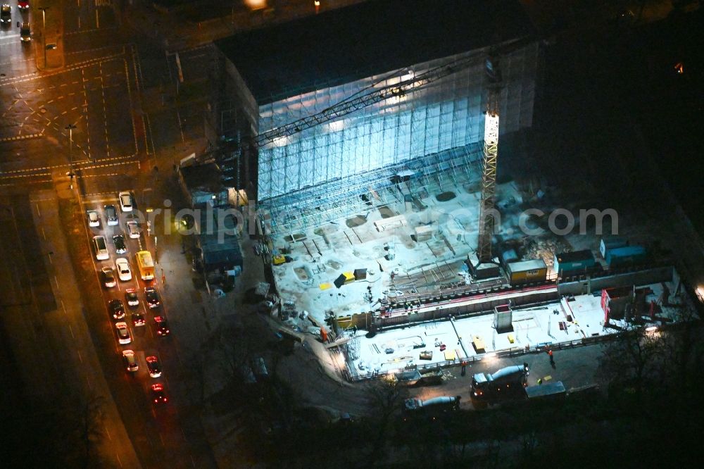 Berlin at night from the bird perspective: Night lighting construction site for the multi-family residential building on Hindenburgdamm corner Koenigsberger Strasse in the district Lichterfelde in Berlin, Germany