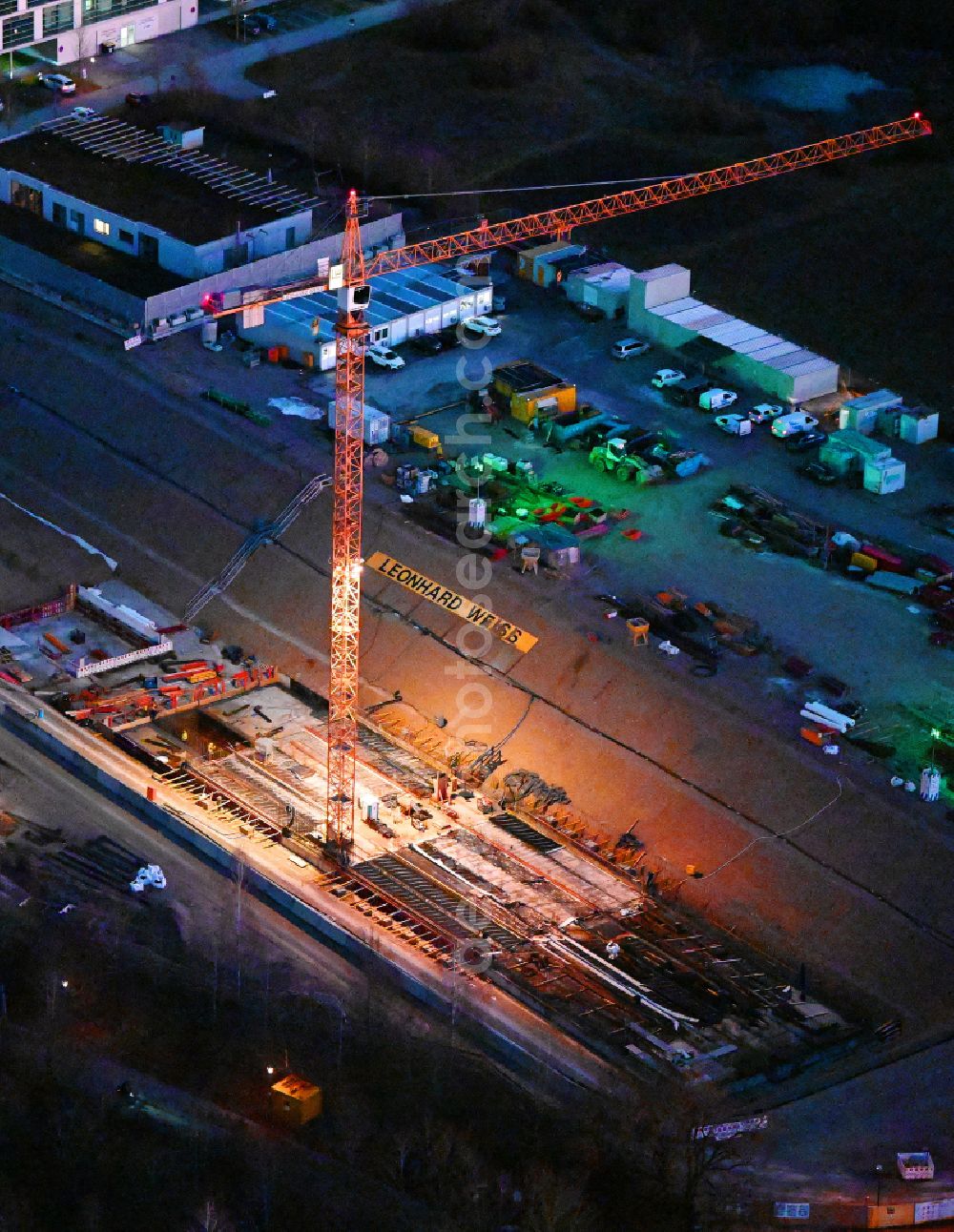 Planegg at night from the bird perspective: Night lighting construction site for the track systems of the metro subway line to street Am Klopferspitz in the district Martinsried in Planegg in the state Bavaria, Germany