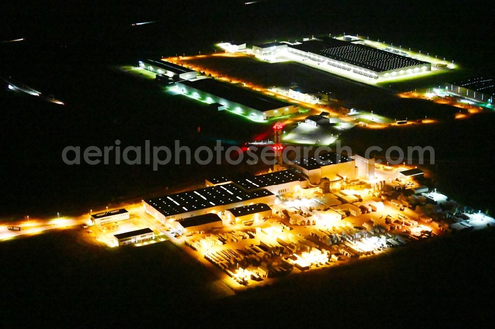 Aerial image at night Bernburg (Saale) - Night lighting building Materials and logistics center of Knauf Insulation GmbH in Bernburg (Saale) in the state Saxony-Anhalt, Germany