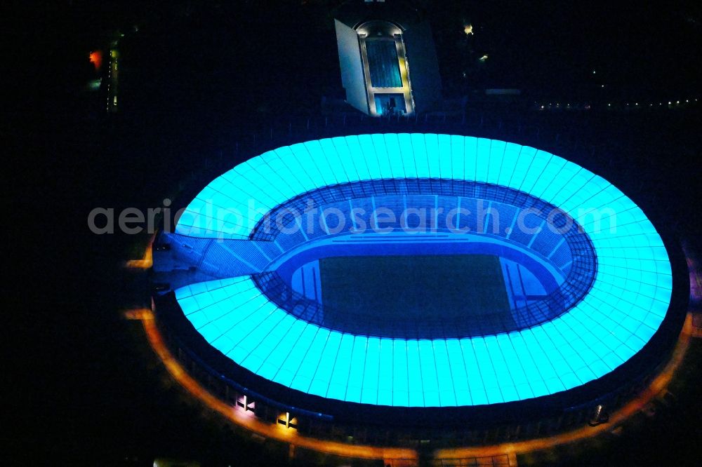 Berlin at night from the bird perspective: Night lighting sports facility grounds of the Arena stadium Olympiastadion of Hertha BSC in Berlin in Germany