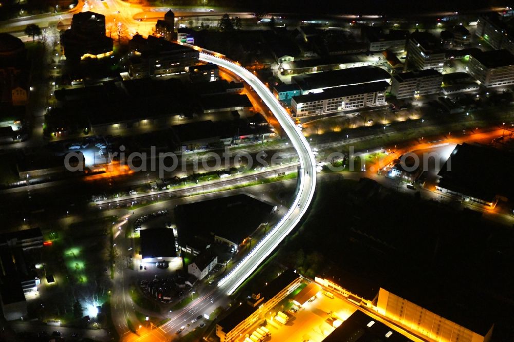 Karlsruhe at night from the bird perspective: Night lighting road bridge construction along of Zeppelinstrasse across the rail course of the local railway course in the district Gruenwinkel in Karlsruhe in the state Baden-Wurttemberg, Germany