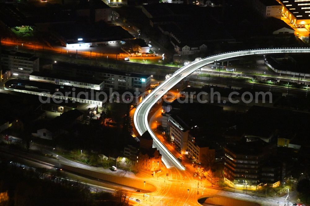Aerial photograph at night Karlsruhe - Night lighting road bridge construction along of Zeppelinstrasse across the rail course of the local railway course in the district Gruenwinkel in Karlsruhe in the state Baden-Wurttemberg, Germany