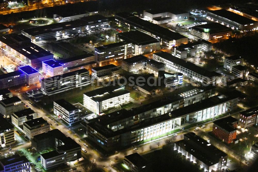 Aerial photograph at night Berlin - Night lighting office building - Ensemble of Scienion AG on Volmerstrasse in the district Johannesthal in Berlin, Germany