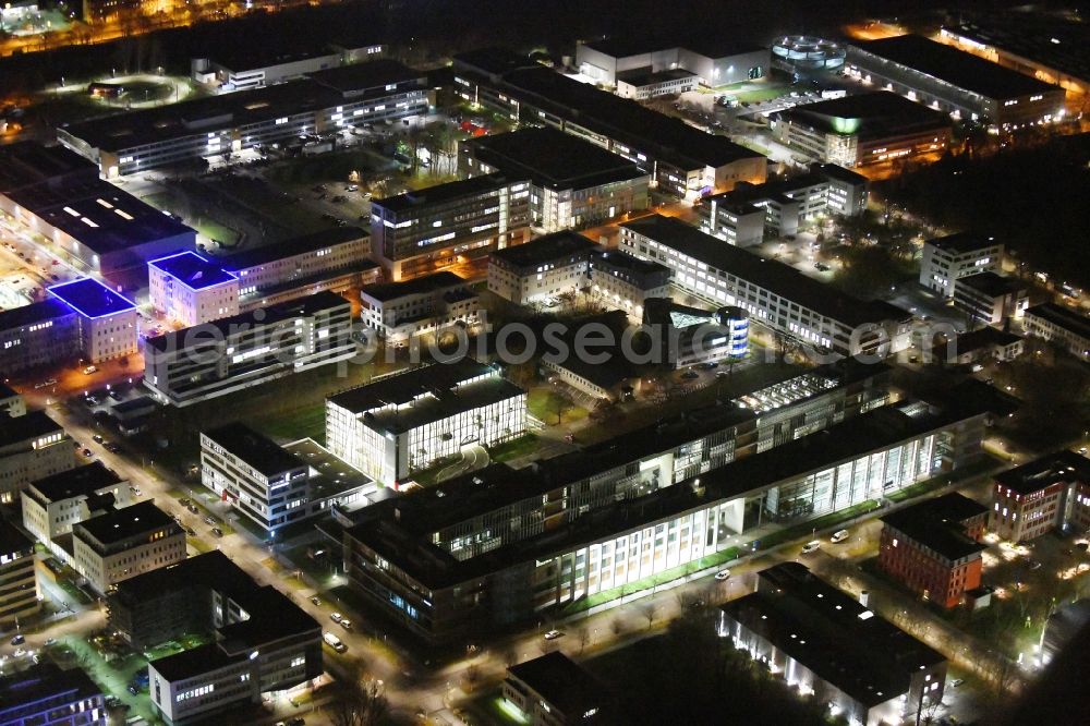 Aerial image at night Berlin - Night lighting office building - Ensemble of Scienion AG on Volmerstrasse in the district Johannesthal in Berlin, Germany