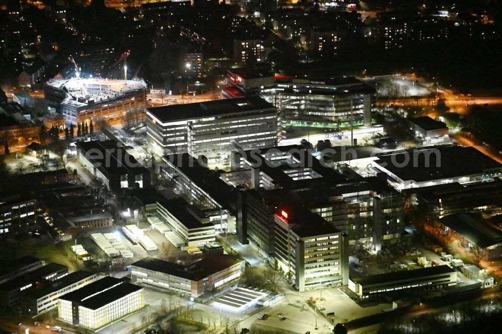 Aerial photograph at night Hamburg - Night lighting office building - Ensemble and structure of OTTO Warenverteilcenter GmbH on Werner-Otto-Strasse in Hamburg, Germany