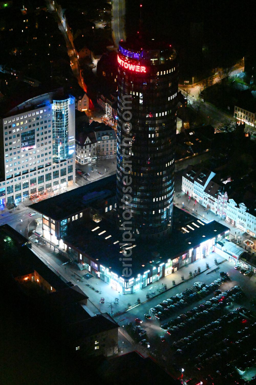 Aerial image at night Jena - Night lighting office and corporate management high-rise building Jentower on Leutragraben in Jena in the state Thuringia, Germany