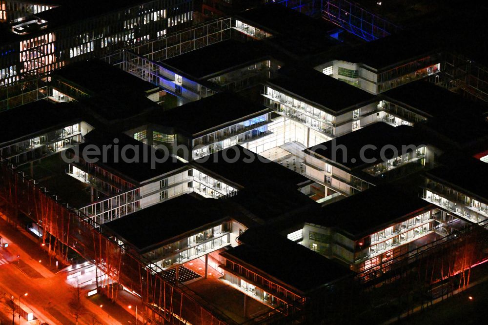 Aerial photograph at night München - Night lighting office building of Allianz Deutschland AG on Dieselstrasse in Unterfoehring in the state Bavaria, Germany