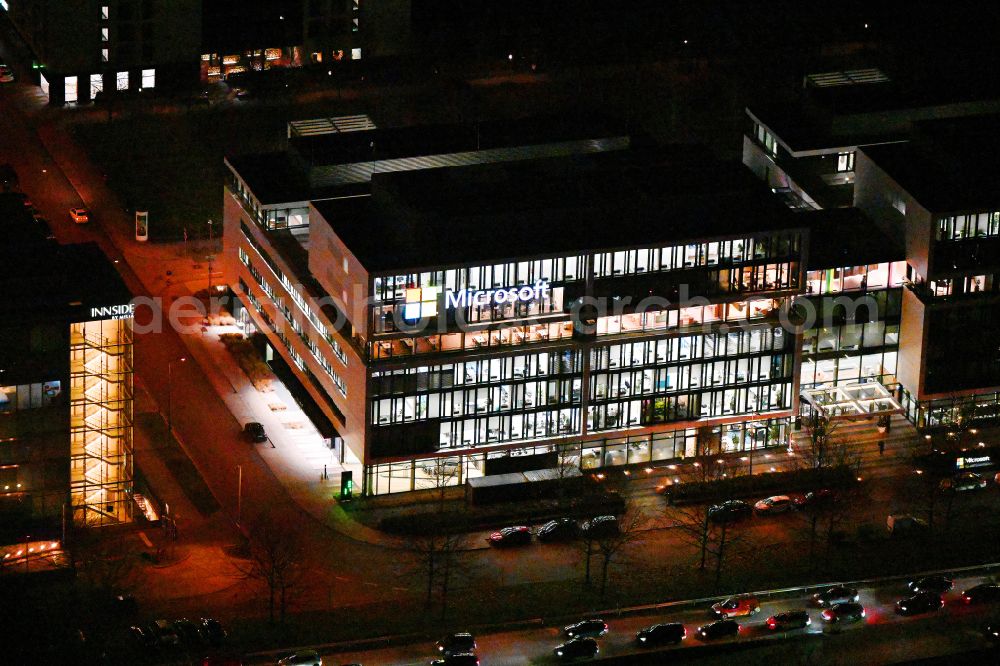 München at night from above - Night lighting office building of Microsoft Deutschland GmbH on street Walter-Gropius-Strasse in the district Freimann in Munich in the state Bavaria, Germany