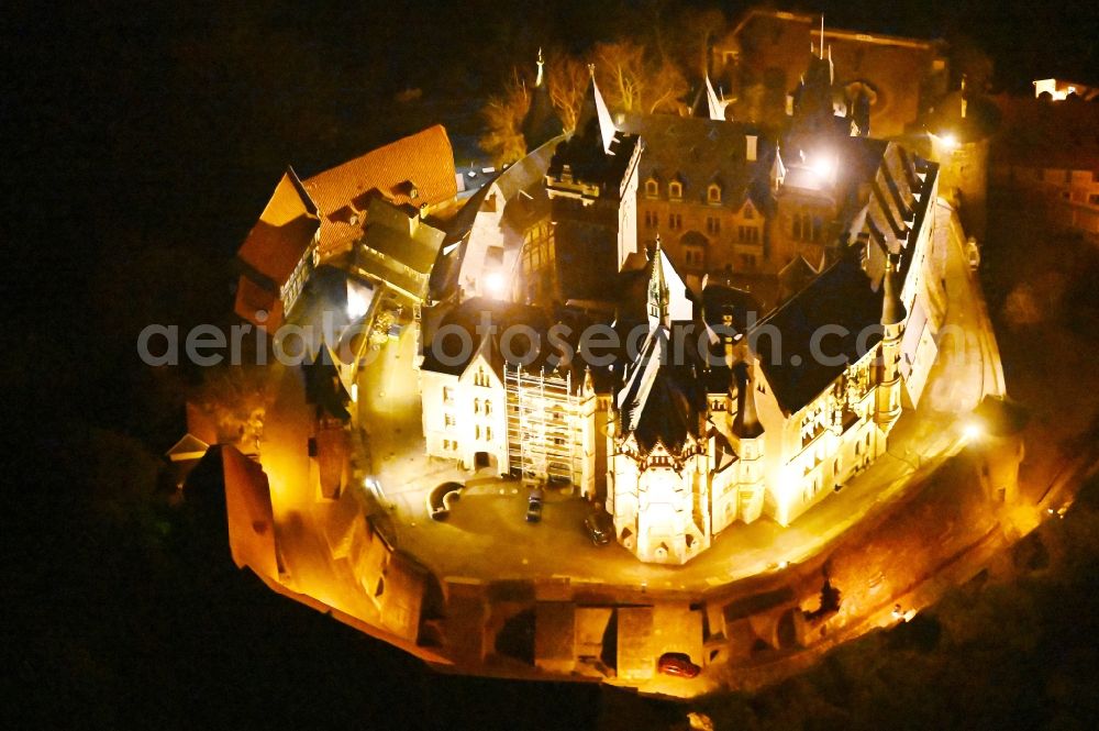 Wernigerode at night from the bird perspective: Night lighting castle of the fortress Schloss Wernigerode in Wernigerode in the state Saxony-Anhalt, Germany