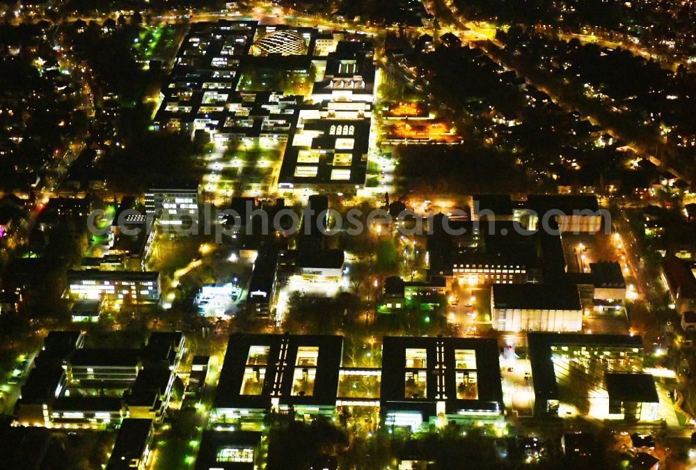 Berlin at night from the bird perspective: Night lighting Campus building of the university Freie Universitaet Berlin on Kaiserswerther Strasse in the district Dahlem in Berlin, Germany