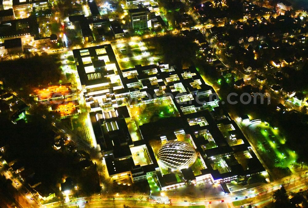 Aerial image at night Berlin - Night lighting Campus building of the university Freie Universitaet Berlin on Kaiserswerther Strasse in the district Dahlem in Berlin, Germany