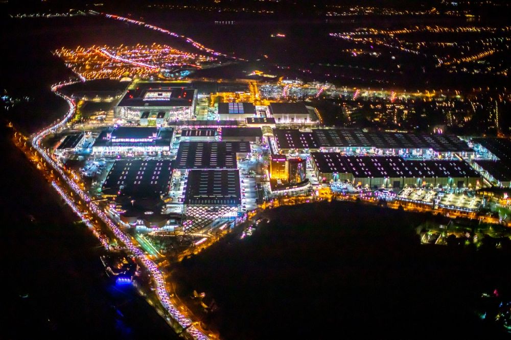 Düsseldorf at night from the bird perspective: Night lighting exhibition grounds and exhibition halls of the Messe Duesseldorf in the district Stockum in Duesseldorf in the state North Rhine-Westphalia, Germany