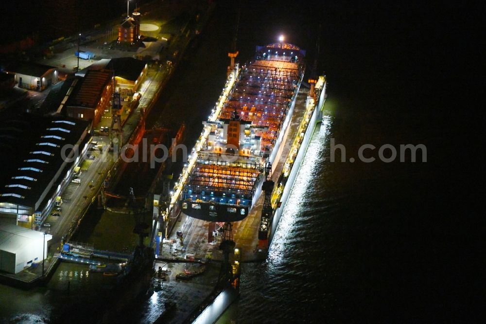 Aerial photograph at night Hamburg - Night lighting container ship PALENA in dry dock in the port in the district Steinwerder in Hamburg, Germany