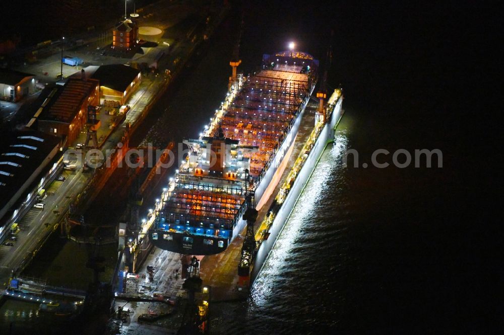 Aerial image at night Hamburg - Night lighting container ship PALENA in dry dock in the port in the district Steinwerder in Hamburg, Germany