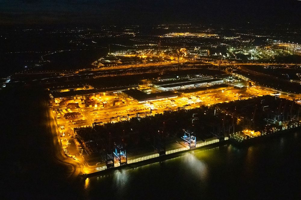 Hamburg at night from above - Night lighting container Terminal HHLA Container Terminal Altenwerder (CTA) on the Elbe riverbank in the Altenwerder part of Hamburg in Germany