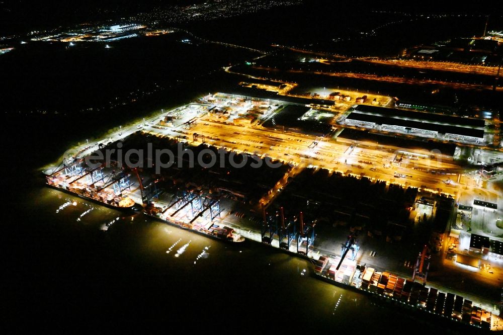 Aerial image at night Hamburg - Night lighting container Terminal HHLA Container Terminal Altenwerder (CTA) on the Elbe riverbank in the Altenwerder part of Hamburg in Germany
