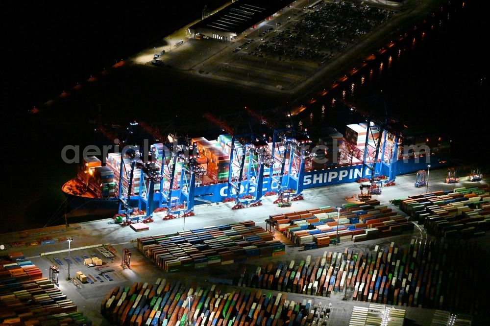 Hamburg at night from the bird perspective: Night lighting container Terminal Tollerort in the port of the international port in district Steinwerder in Hamburg with sewage works Koehlbrandhoeft