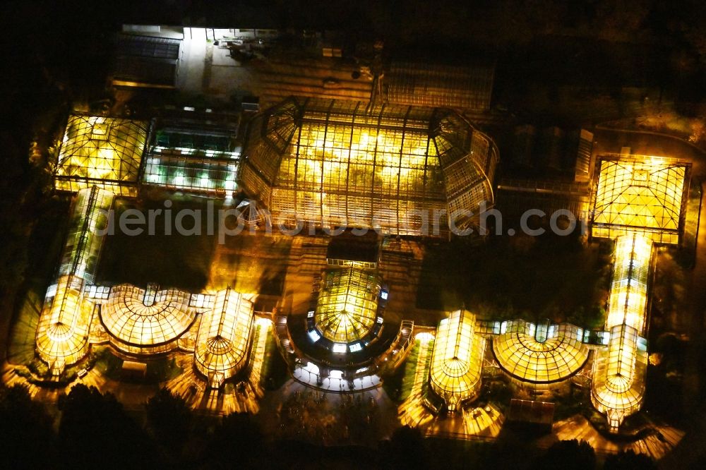 Berlin at night from the bird perspective: Main building and greenhouse complex of the Botanical Gardens Berlin-Dahlem in Berlin. The historical glass buildings and greenhouses are dedicated to different areas. The Large Tropical House and the Victoria-House are located in the center