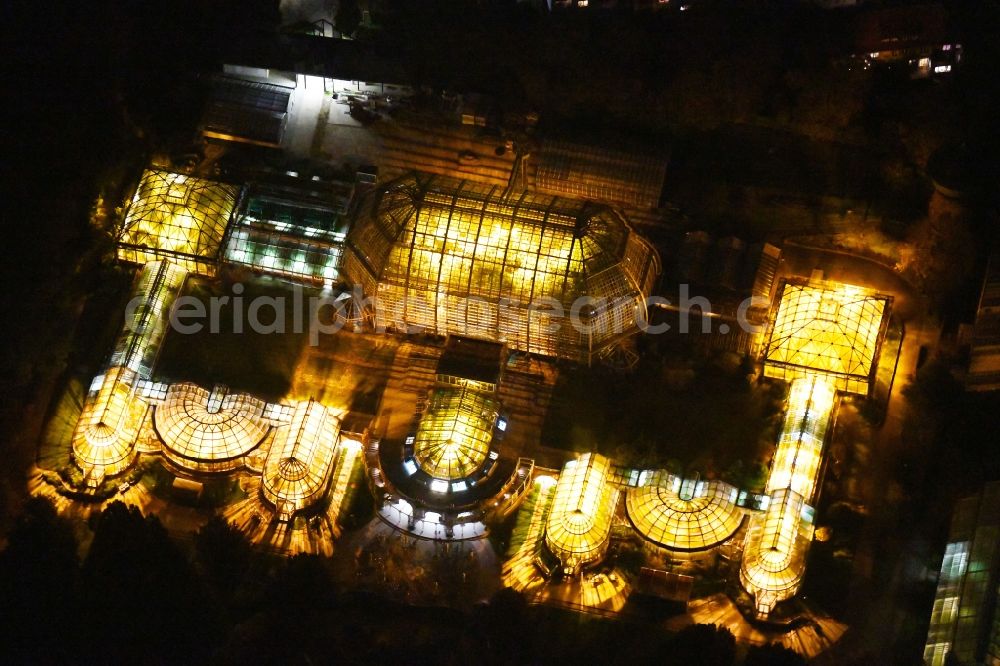 Aerial photograph at night Berlin - Main building and greenhouse complex of the Botanical Gardens Berlin-Dahlem in Berlin. The historical glass buildings and greenhouses are dedicated to different areas. The Large Tropical House and the Victoria-House are located in the center