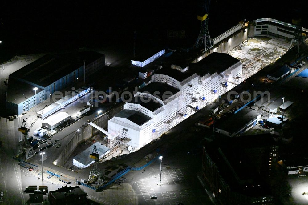Hamburg at night from above - Night lighting ship's hull of Yacht Dilbar in Dock Elbe 17 in dry dock on the shipyard site in the district Steinwerder in Hamburg, Germany