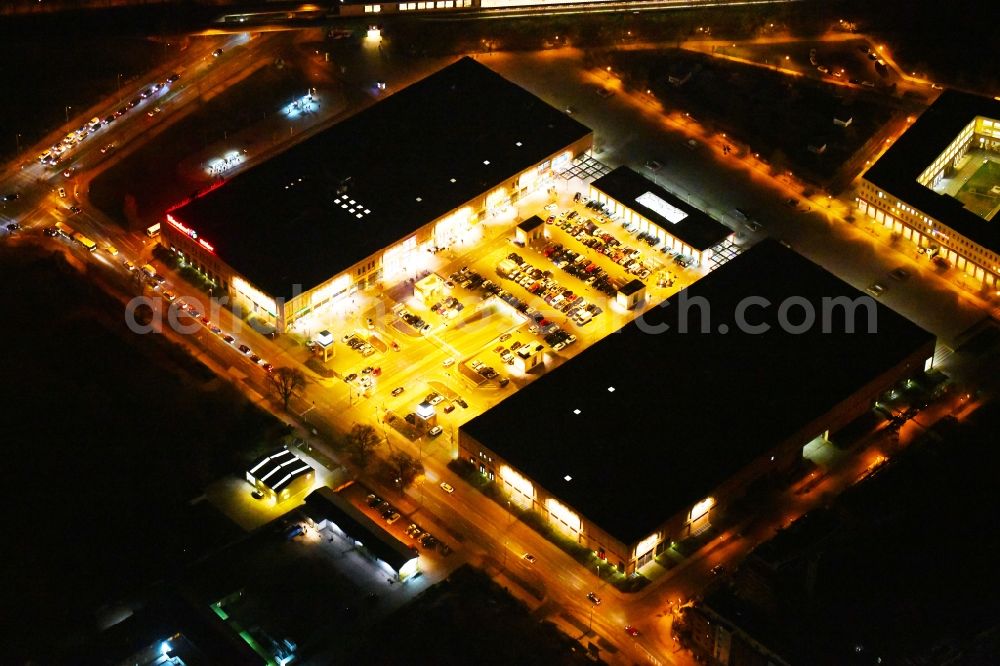 Aerial image at night Berlin - Night lighting of the shopping Mall Biesdorf Center on Weissenhoher Strasse in Berlin Biesdorf