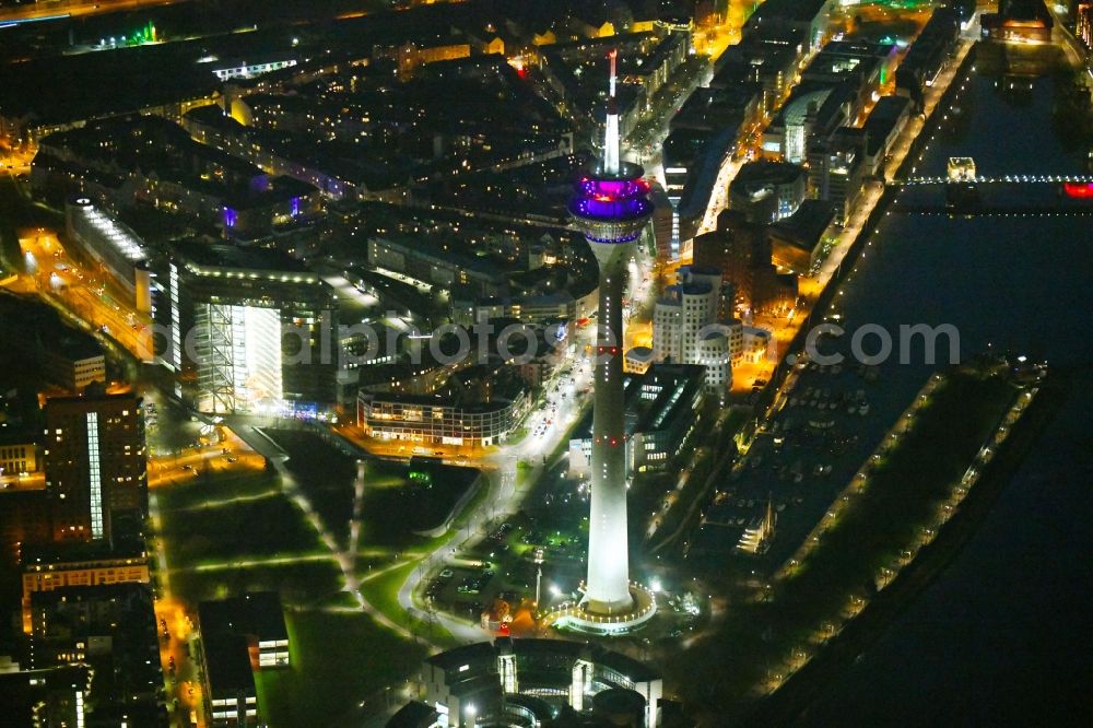 Düsseldorf at night from the bird perspective: Night lighting top of the Television Tower Rheinturm with the city center in the background in Duesseldorf in the state North Rhine-Westphalia