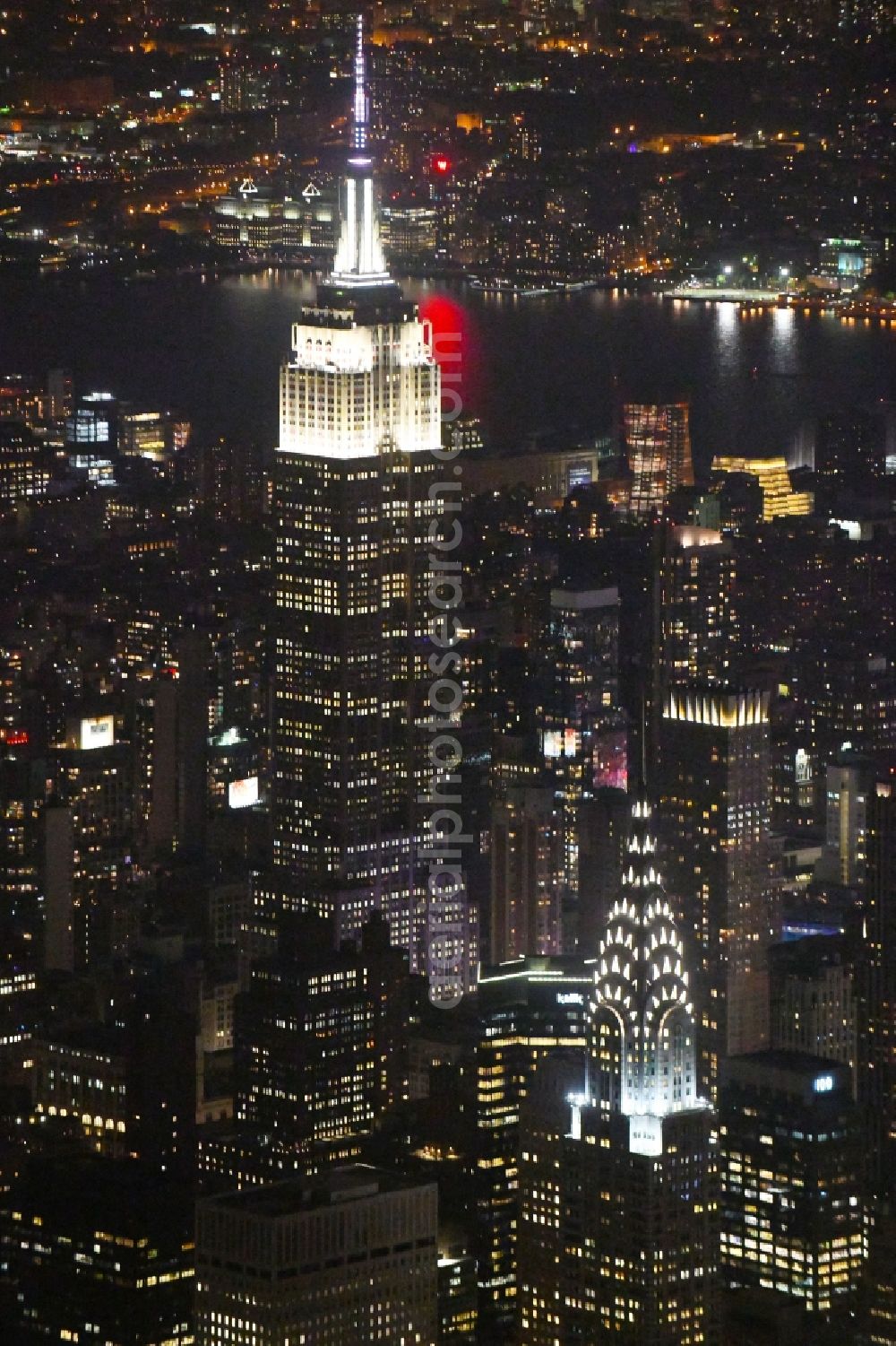 Aerial image at night New York - Night lighting High-rise buildings Empire State Building 5th Avenue in New York in United States of America