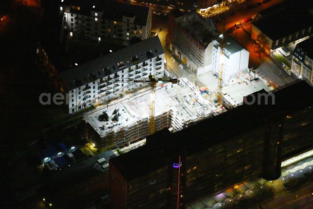 Aerial image at night Berlin - Night lighting construction site for the new residential and commercial Corner house - building on Rathausstrasse in the district Lichtenberg in Berlin, Germany