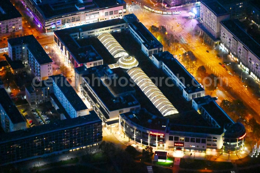 Aerial image at night Magdeburg - Night lighting Building of the shopping center Allee-Center Magdeburg on street Ernst-Reuter-Allee in the district Zentrum in Magdeburg in the state Saxony-Anhalt, Germany