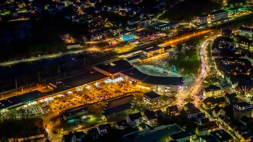 Soest at night from the bird perspective: Night lighting building of the shopping center City Center Soest at the train station in Soest in the state North Rhine-Westphalia, Germany