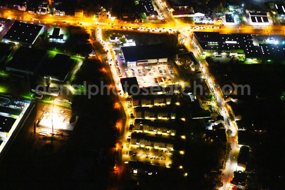 Berlin at night from the bird perspective: Night lighting Building of the shopping center EDEKA Center Brehm and dm-drogerie markt in Berlin, Germany