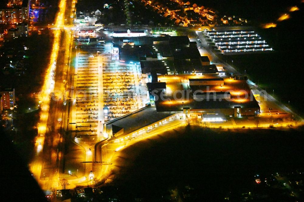 Aerial image at night Eiche - Night lighting building of the shopping center Eiche of Unibail-Rodamco Germany GmbH on Landsberger Chaussee corner Hellersdorfer Weg in Eiche in the state Brandenburg, Germany