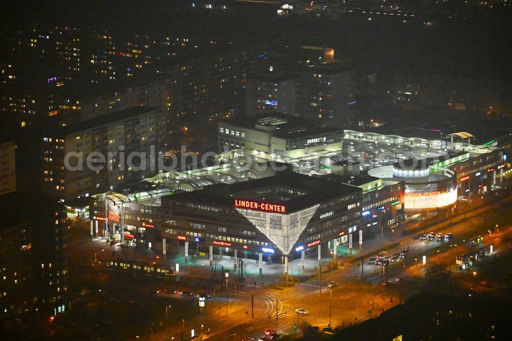 Aerial image at night Berlin - Night lighting building of the shopping center Linden-Center Berlin on Prerower Platz in the district Neu-Hohenschoenhausen in the district Hohenschoenhausen in Berlin, Germany