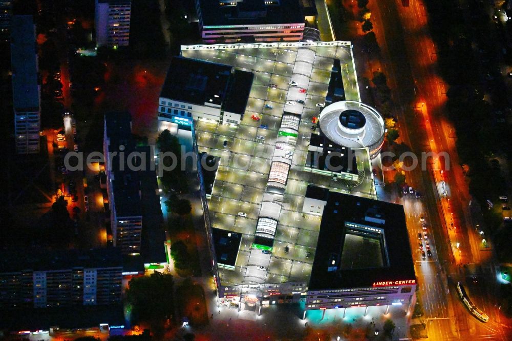 Aerial image at night Berlin - Night lighting building of the shopping center Linden-Center Berlin on Prerower Platz in the district Neu-Hohenschoenhausen in the district Hohenschoenhausen in Berlin, Germany