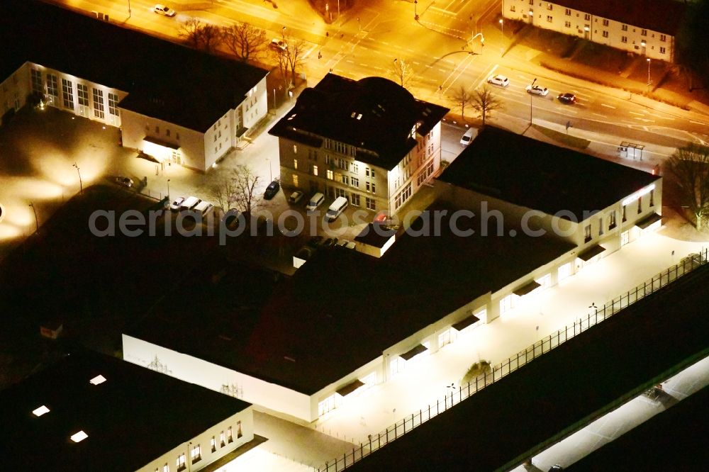 Aerial image at night Ludwigsfelde - Night lighting Building of the shopping center Ludwig Arkaden of McCafferty Asset Management GmbH in Ludwigsfelde in the state Brandenburg, Germany