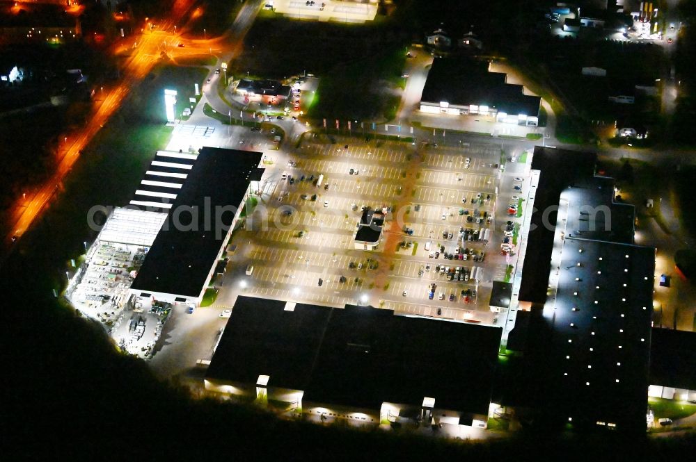 Aerial photograph at night Blankenburg (Harz) - Night lighting parking space for parked cars at the shopping center Nordharz Center on Lerchenbreite in Blankenburg (Harz) in the state Saxony-Anhalt, Germany