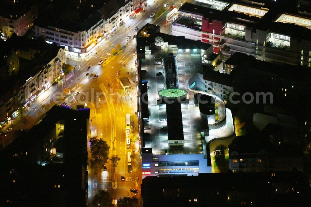 Aerial photograph at night Berlin - Night lighting building of the shopping center Schloss-Strassen-Center Berlin on place Walther-Schreiber-Platz in the district Friedenau in Berlin, Germany