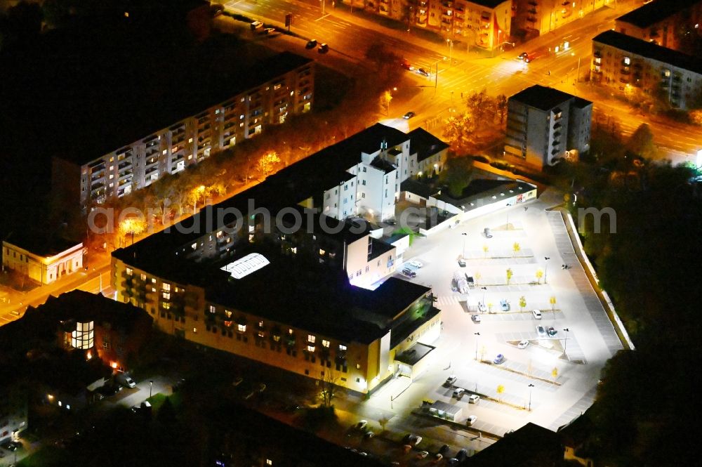 Dessau at night from above - Night lighting parking space for parked cars at the shopping center Wagner Passage in Dessau in the state Saxony-Anhalt, Germany