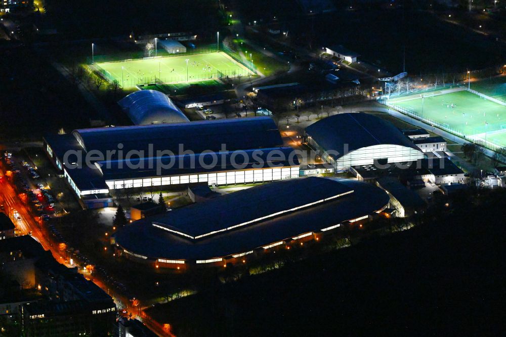 Berlin at night from above - Night lighting ensemble of sports grounds and Eisschnelllaufhalle in Sportforum Berlin Konrad-Wolf-Strasse in the district Hohenschoenhausen in Berlin, Germany