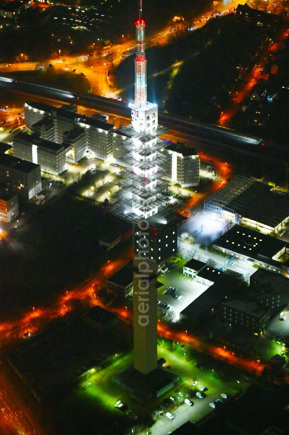 Aerial image at night Hannover - Night lighting Television Tower of DFMG Deutsche Funkturm GmbH on Neue-Land-Strasse in the district Buchholz-Kleefeld in Hannover in the state Lower Saxony, Germany