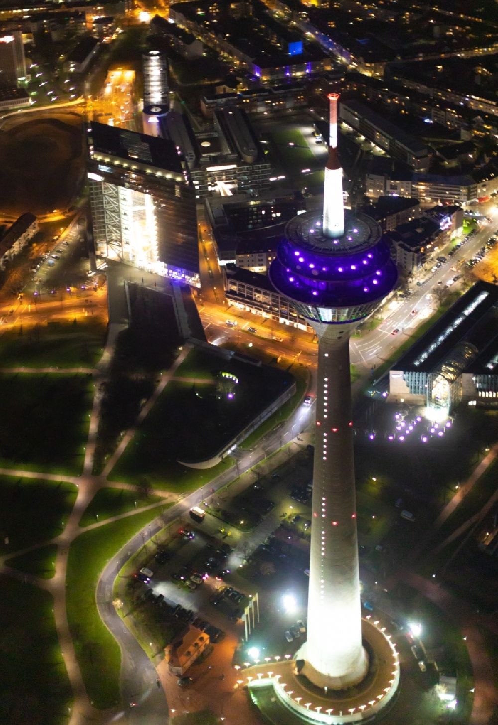 Düsseldorf at night from the bird perspective: Night lighting top of the Television Tower Rheinturm with the city center in the background in Duesseldorf in the state North Rhine-Westphalia