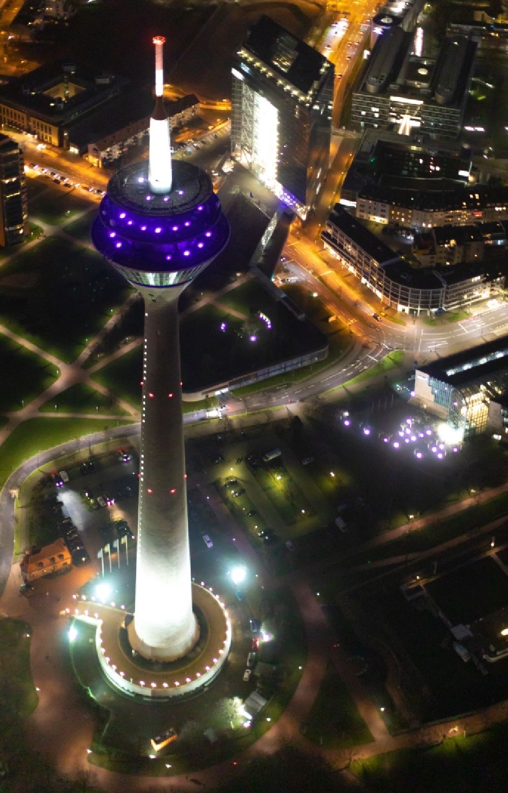 Aerial image at night Düsseldorf - Night lighting top of the Television Tower Rheinturm with the city center in the background in Duesseldorf in the state North Rhine-Westphalia